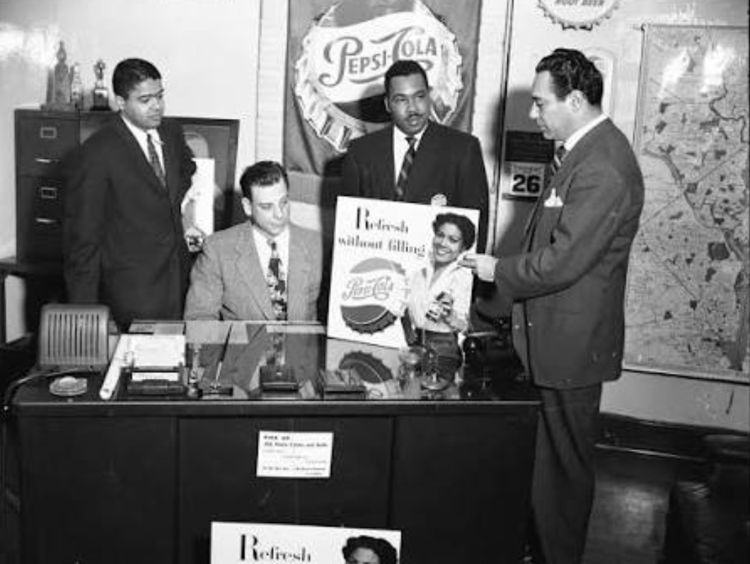 A 1940s Pepsi-Cola advertising team reviewing campaign art